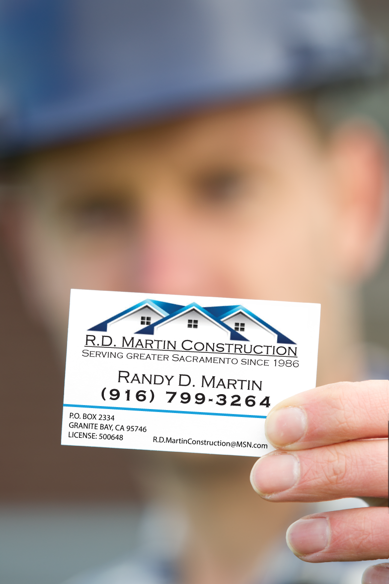 Construction man holding business card